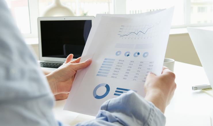 Person holding a credit report document in a office setting